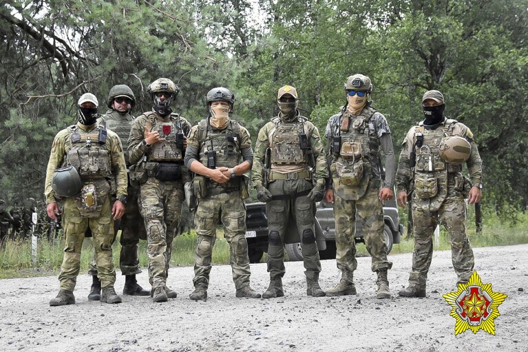 FILE - In this photo released by the Belarusian Defense Ministry on Thursday, July 20, 2023, soldiers of the Special Operations Forces and mercenary fighters from the Wagner private military company pose for a photo amid maneuvers at a firing range near the border city of Brest, Belarus. (Belarus Defense Ministry via AP, File)
