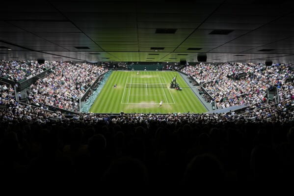 FILE - Ukraine's Elina Svitolina, top, plays Czech Republic's Marketa Vondrousova in a women's singles semifinal match on day eleven of the Wimbledon tennis championships in London, Thursday, July 13, 2023. Wimbledon's total prize money fund will rise to a record 50 million pounds (about $64 million), with the singles champions each earning 2.7 million pounds ($3.45 million), All England Club officials announced Thursday, June 13, 2024. (AP Photo/Kirsty Wigglesworth, File)
