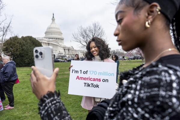 Devotees of TikTok, Mona Swain, center, and her sister, Rachel Swain, right, both of Atlanta, monitor voting at the Capitol in Washington, March 13, 2024. (AP Photo/J. Scott Applewhite, File)