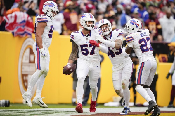 Buffalo Bills defensive end AJ Epenesa (57) celebrating with teammates after scoring a touchdown against the Washington Commanders during the second half of an NFL football game, Sunday, Sept. 24, 2023, in Landover, Md. (AP Photo/Andrew Harnik)