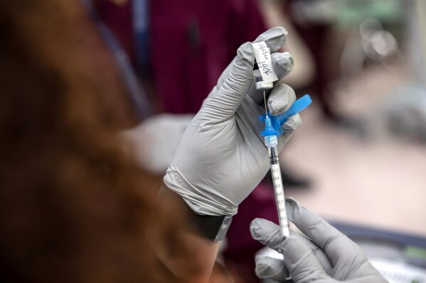 The first Pfizer-BioNTech COVID-19 vaccination to be administered in New Jersey is prepared at University Hospital, in Newark, NJ, Tuesday Dec. 15, 2020. (Kirsten Luce/The New York Times via AP, Pool)
