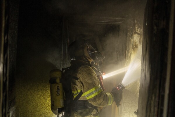 Firefighters extinguish a fire in a residential building damaged after a Russian attack in Kyiv, Ukraine, Saturday, May 24, 2025 (AP Photo/Alex Babenko)