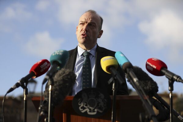 Northern Ireland Secretary Chris Heaton-Harris speaks to the media outside Hillsborough Castle where political parties have reconvened for more talks with and the Government on a financial package for the region, in Belfast, Northern Ireland, Tuesday Dec. 19, 2023. The British government said Tuesday it will give Northern Ireland 3.3 billion pounds ($4.2 billion) to ease a budget crisis if stubborn lawmakers stop boycotting the suspended power-sharing Belfast government. Northern Ireland Secretary Chris Heaton-Harris said the financial package was a final offer and urged the holdout Democratic Unionist Party to get back to governing.(Liam McBurney/PA via AP)