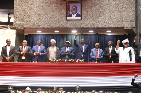 Representatives of Rapid Support Forces (RSF) sing during a planned signing ceremony of the Sudan Founding Charter aimed at establishing a unity government involving leaders of political forces, armed groups, and the Rapid Support Forces (RSF) at the Kenyatta International Convention Centre (KICC) in Nairobi, Tuesday, Feb. 18, 2025. (AP Photo/Andrew Kasuku)