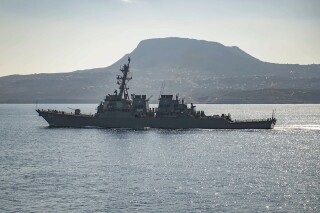 FILE - The guided-missile destroyer USS Carney in Souda Bay, Greece. The American warship and multiple commercial ships came under attack Sunday, Dec. 3, 2023 in the Red Sea, the Pentagon said, potentially marking a major escalation in a series of maritime attacks in the Mideast linked to the Israel-Hamas war. 