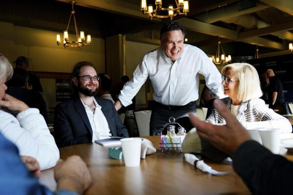 FILE - Dave McCormick, a Republican candidate for U.S. Senate in Pennsylvania, meets with attendees during a campaign event in Warminster, Pa., March 7, 2022. (AP Photo/Matt Rourke)