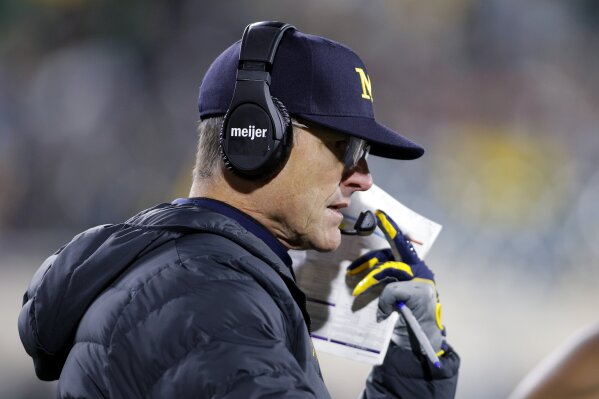 Michigan coach Jim Harbaugh looks on during the second half of an NCAA college football game against Michigan State, Saturday, Oct. 21, 2023, in East Lansing, Mich. (AP Photo/Al Goldis)