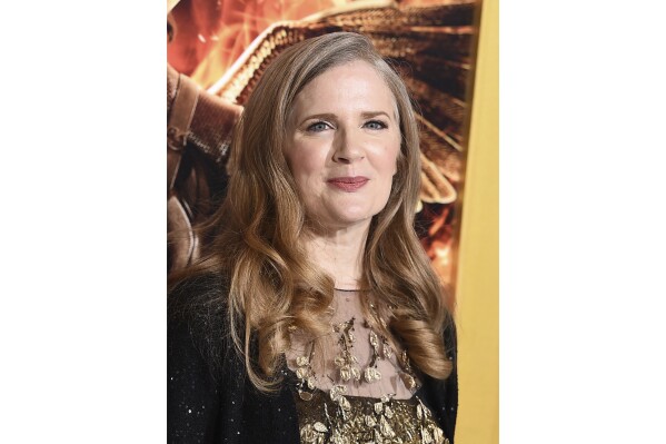FILE - Suzanne Collins arrives at the Los Angeles premiere of "The Hunger Games: Mockingjay - Part 1" at the Nokia Theatre L.A. Live on Nov. 17, 2014. Collins is returning to the ravaged, post-apocalyptic land of Panem for a new “The Hunger Games” novel. Scholastic announced Thursday that “Sunrise on the Reaping” will be published March 18, 2025. (Photo by Jordan Strauss/Invision/AP, File)