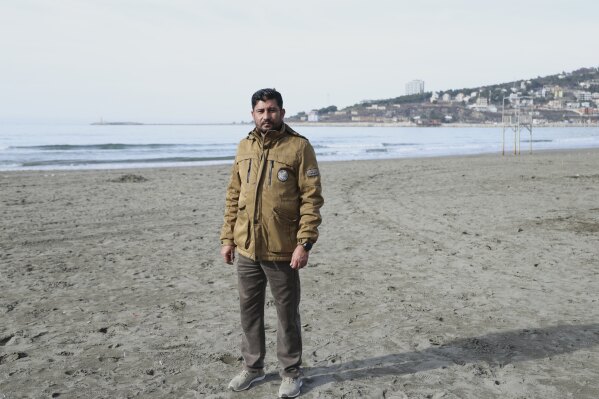 Afghan Hashmatullah Alam, 40, who worked with U.S. Army, poses at a beach in Shengjin, northwestern Albania, Monday, Jan. 27, 2025. (AP Photo/Vlasov Sulaj)