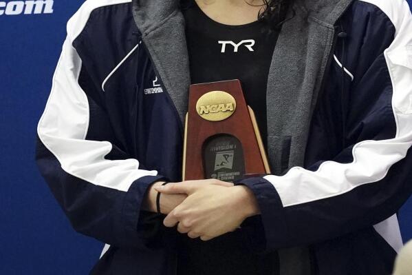 Pennsylvania's Lia Thomas holds the fifth-place trophy after the 200 freestyle final at the NCAA  women's swimming and diving championships Friday, March 18, 2022, at Georgia Tech in Atlanta. Thomas finished tied for fifth place. (AP Photo/John Bazemore)