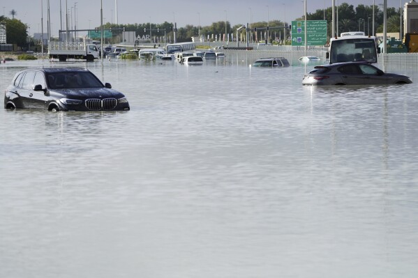 Vehicles sit abandoned in floodwaters covering a road in Dubai, United Arab Emirates, April 17, 2024. With cloud seeding, it may rain, but it doesn’t really pour or flood — at least nothing like what drenched the United Arab Emirates and paralyzed Dubai. (AP Photo/Jon Gambrell)