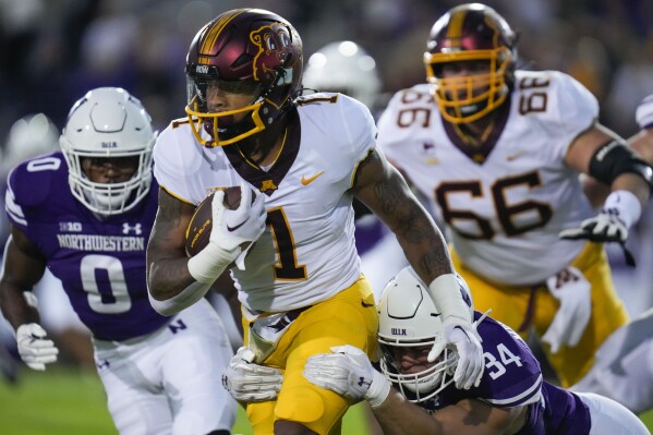 Minnesota running back Darius Taylor (1) is tackled by Northwestern linebacker Xander Mueller (34) during the first half of an NCAA college football game Saturday, Sept. 23, 2023, in Evanston, Ill. (AP Photo/Erin Hooley)