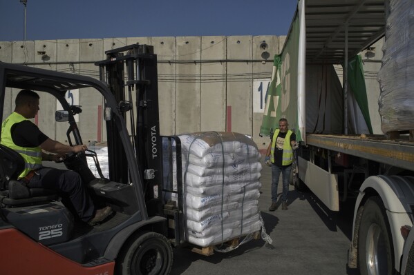 Israel may change tack to allow aid groups in Gaza to stay in charge of  non-food aid | AP News