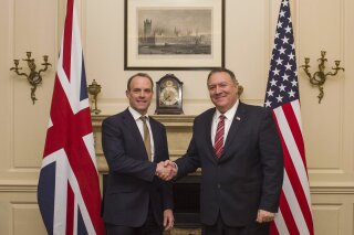 UK Foreign Secretary Dominic Raab shakes hands with US Secretary of State Mike Pompeo, right, in London, Wednesday Jan. 29, 2020.  Pompeo is in the UK for high level trade talks ahead of Britain's exit from the European Union on upcoming Friday. (Peter Summers/Pool via AP)