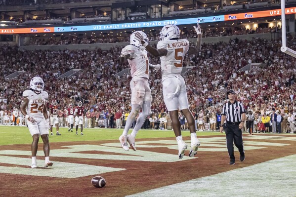 Texas wide receiver Xavier Worthy (1) and Texas wide receiver Adonai Mitchell (5) celebrate a touchdown by Worthy against Alabama during the second half of an NCAA college football game Saturday, Sept. 9, 2023, in Tuscaloosa, Ala. (AP Photo/Vasha Hunt)