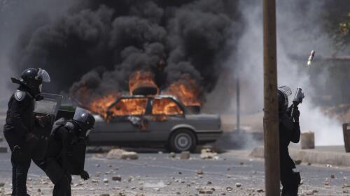 A riot police officer shots tear gas at demonstrators during a protest at the Cheikh Anta Diop University campus in Dakar, Senegal, Thursday, June 1, 2023. Senegal opposition leader Ousmane Sonko was convicted Thursday of corrupting youth but acquitted on charges of raping a woman who worked at a massage parlor and making death threats against her. (AP Photo/Leo Correa)