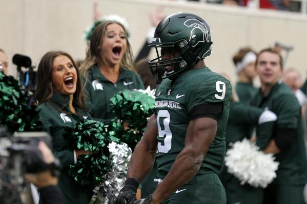 Michigan State's Kenneth Walker III celebrates his touchdown against Michigan during the second quarter of an NCAA college football game, Saturday, Oct. 30, 2021, in East Lansing, Mich. (AP Photo/Al Goldis)