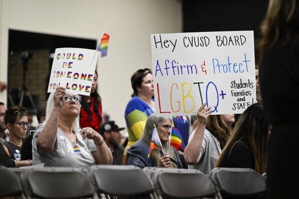 Parents, students, and staff of Chino Valley Unified School District hold up signs in favor of protecting LGBTQ+ policies at Don Antonio Lugo High School, in Chino, Calif., June 15, 2023. (Anjali Sharif-Paul/The Orange County Register via AP, File)