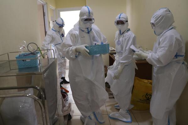 Health workers prepare to treat a COVID-19 patient at the Dr. Suyoto General Hospital in Jakarta, Indonesia, on July 29, 2021. As coronavirus cases skyrocket and deaths climb in Indonesia, health care workers are being depleted as the virus spares nobody. (AP Photo/Tatan Syuflana)