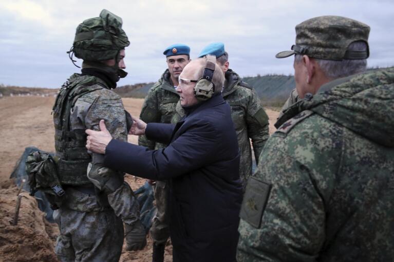 Russian President Vladimir Putin, center, speaks to a soldier as he visits a military training centre of the Western Military District for mobilized reservists in the Ryazan region of Russia, on Oct. 20, 2022. Defense Minister Sergei Shoigu is seen back to camera. Putin sent Russian forces into Ukraine on Feb. 24, 2022, and appears determined to prevail. (Mikhail Klimentyev, Sputnik, Kemlin Pool Photo via AP, File)