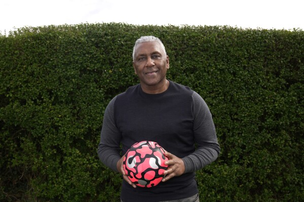 Former England international soccer player Ricky Hill poses for a photograph in Luton, England, Wednesday, March 20, 2024. Racism has long permeated the world’s most popular sport, with soccer players subjected to racist chants and taunts online. While governing bodies like FIFA and UEFA have taken steps to combat the abuse of players, the lack of diversity in the upper ranks at major clubs remains an unsolved problem. Hill has just left the U.K. to take a management position with a suburban Chicago soccer club. (AP Photo/Kin Cheung)