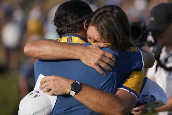 Europe's Tommy Fleetwood celebrates on the 17th green after winning his singles match at the Ryder Cup golf tournament at the Marco Simone Golf Club in Guidonia Montecelio, Italy, Sunday, Oct. 1, 2023. (AP Photo/Andrew Medichini)