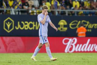 Barcelona's Frenkie de Jong walks from the pitch after being given a red card during a Spanish La Liga soccer match between Cadiz and Barcelona at the Nuevo Mirandilla stadium in Cadiz, Spain, Thursday, Sept. 23, 2021. (AP Photo/Miguel Morenatti)