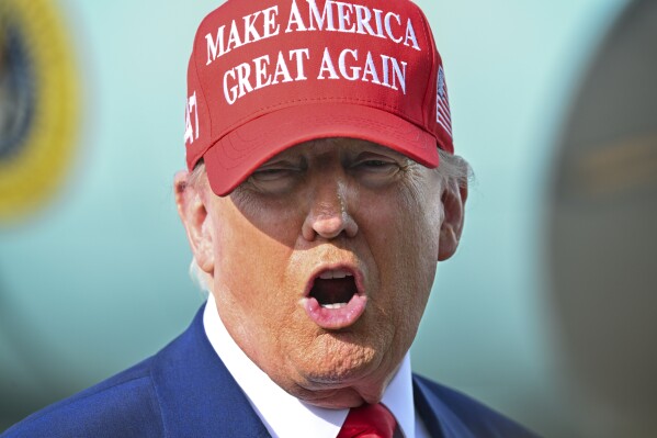 President Donald Trump speaks to reporters after landing at Palm Beach International Airport in West Palm Beach, Fla ., Sunday, Feb. 16, 2025, after attending the NASCAR Daytona 500 auto race. (Pool via AP)