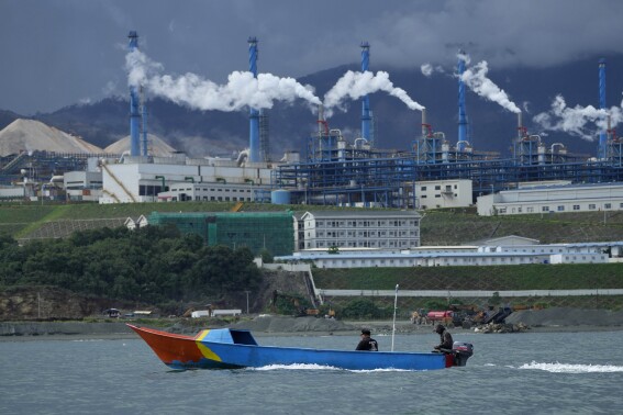 A boat cruises past the Indonesia Weda Bay Industrial Park in Central Halmahera, North Maluku province, Indonesia, Saturday, June 8, 2024. Indonesia has been building out a vast industry for nickel. (AP Photo/Achmad Ibrahim)