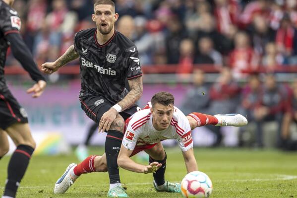 Leverkusen's Robert Andrich, left, and Berlin's Janik Haberer, right, challenge for the ball during the German Bundesliga soccer match between 1. FC Union Berlin and Bayer 04 Leverkusen in Berlin, Germany, Saturday, April 29, 2023.Andreas Gora/dpa via AP)