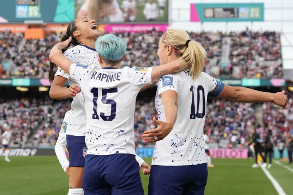 United States' Lindsey Horan, right, celebrates with Sophia Smith, left, and Megan Rapinoe after scoring during the Women's World Cup soccer match between the United States and Vietnam at Eden Park in Auckland, New Zealand, Saturday, July 22, 2023. (AP Photo/Abbie Parr)