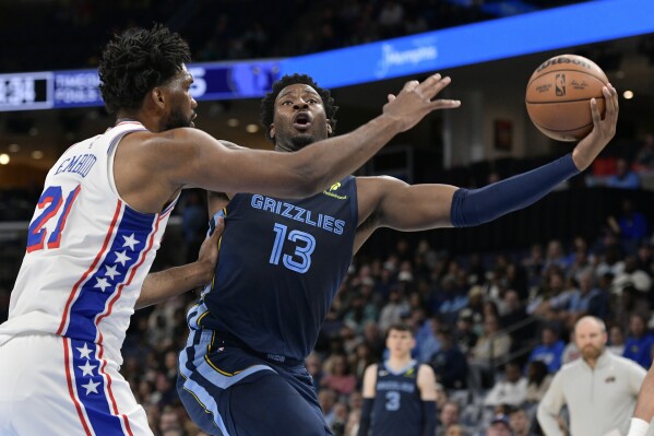 Memphis Grizzlies forward Jaren Jackson Jr. (13) shoots against Philadelphia 76ers center Joel Embiid (21) in the first half of an NBA basketball game Wednesday, Nov. 20, 2024, in Memphis, Tenn. (AP Photo/Brandon Dill)