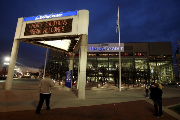 FILE - The marquee in front of the Energy Solutions Arena, formerly the Delta Center, home of the Utah Jazz, shows conflicting signage at dusk before a game against the Toronto Raptors, Monday, Nov. 20, 2006, in Salt Lake City. Preparations are being made in case an NHL team is in Salt Lake City sooner than later. Prospective owner Ryan Smith earlier this week solicited public suggestions for a team name. All this comes as the Arizona Coyotes are hoping to win a land auction for a site to build a new arena in the city of Phoenix. (AP Photo/Steve C. Wilson, File)