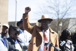 Attorney Ben Crump raises a fist and says "justice for Gershun Freeman" while the Freeman family and the parents of Tyre Nichols stand next to him to address Freeman's death while in custody during a news conference outside of the Shelby County Criminal Justice Center in Memphis, Tenn., on Friday, March 17, 2023. Gershun Freeman died in custody last fall after Memphis jailers punched, kicked and kneeled on his back during a confrontation are seeking answers for their son and punishments against the jail staff. (Chris Day/The Commercial Appeal via AP)