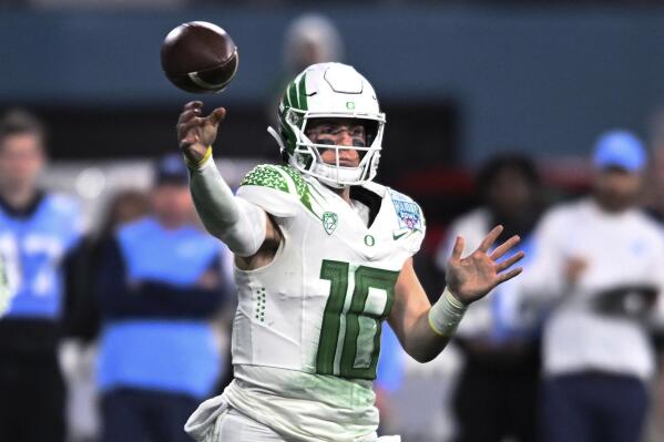 FILE -Oregon quarterback Bo Nix throws a pass during the second half of the team's Holiday Bowl NCAA college football game against North Carolina on Wednesday, Dec. 28, 2022, in San Diego. Bo Nix has settled in at Oregon, ready for a better outcome in his final year with the Ducks. The senior quarterback was getting Heisman buzz for a time last season before he got injured and the Ducks got derailed. (AP Photo/Denis Poroy, File)