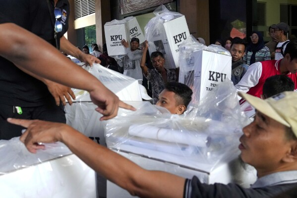 Workers load ballot boxes onto a truck to be distributed to polling stations ahead of the Feb. 14 election, in Jakarta, Indonesia, Tuesday, Feb. 13, 2024. Indonesia, the world's third-largest democracy, will open its polls on Wednesday to nearly 205 million eligible voters in presidential and legislative elections, the fifth since Southeast Asia's largest economy began democratic reforms in 1998. (AP Photo/Tatan Syuflana)
