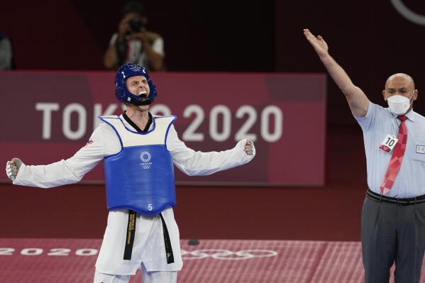 Vladislav Larin of the Russian Olympic Committee, left, reacts as the referee signals his win for a gold medal for taekwondo men's 80kg match at the 2020 Summer Olympics, Tuesday, July 27, 2021, in Tokyo, Japan. (AP Photo/Themba Hadebe)