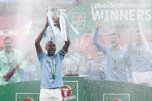 Manchester City's team captain Fernandinho lifts the trophy at the end of the English League Cup final soccer match between Manchester City and Tottenham Hotspur at Wembley stadium in London, Sunday, April 25, 2021. Manchester City won 1-0. (AP Photo/Alastair Grant)
