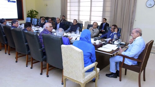FILE - In this photo released by Press Information Department, Prime Minister Prime Minister Shahbaz Sharif, right, chairs a meeting regarding ongoing crackdown against human smugglers, in Islamabad, Pakistan on June 21, 2023. The government has also launched a crackdown on the human traffickers who arranged travel for the Pakistanis on the fishing boat, many of whom were seeking jobs in Europe. So far, police have arrested at least 17 suspected traffickers in connection with the case.(Press Information Department via AP, File)