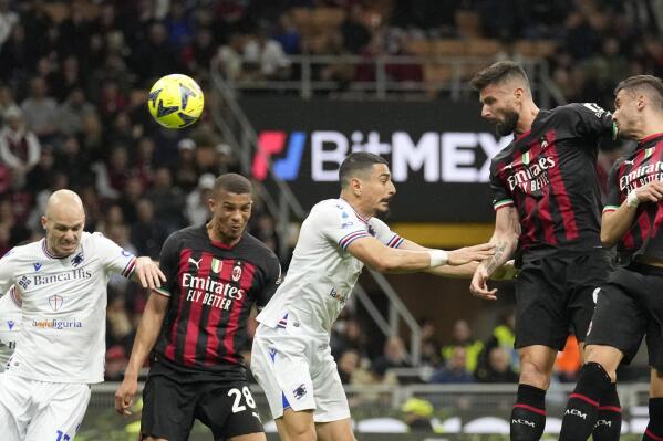 AC Milan's Olivier Giroud, right, heads the ball to score his side's second goal during a Serie A soccer match between AC Milan and Sampdoria , at the San Siro stadium in Milan, Italy, Saturday, May 20, 2023. (AP Photo/Antonio Calanni)