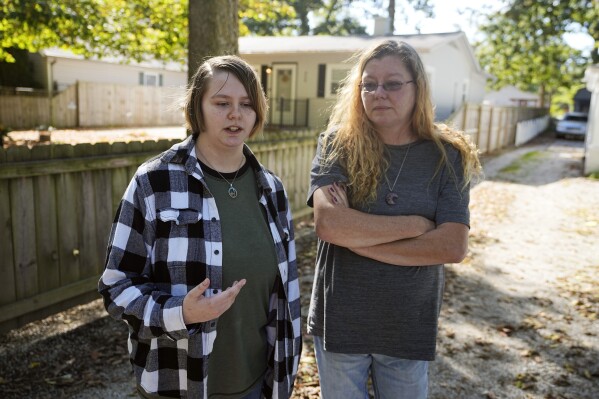 Caston Peters and their mom, Kim Michaelis-Peters, speak about restricting students from using pronouns or names that don't match their sex assigned at birth, Friday, Oct. 6, 2023, in Indianapolis. Indiana is among at least 10 states that have enacted laws prohibiting or restricting students from using pronouns or names that don't match their sex assigned at birth, a restriction that opponents say further marginalizes transgender and nonbinary students. (AP Photo/Darron Cummings)