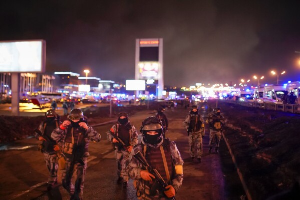 Russian Rosguardia (National Guard) servicemen secure an area at the Crocus City Hall on the western edge of Moscow, Russia, on Saturday, March 23, 2024. (Alexander Avilov/Moscow News Agency via AP)