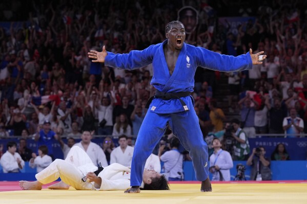 France's Joan-Benjamin Gaba celebrates after defeating Japan's Hifumi Abe during men's -73 kg of the mixed team final match in the team judo competition, at Champ-de-Mars Arena, during the 2024 Summer Olympics, Saturday, Aug. 3, 2024, in Paris, France. (AP Photo/Eugene Hoshiko)