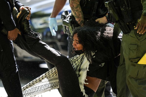 Authorities arrest a protester on the campus of Emory University during a pro-Palestinian demonstration, Thursday, April 25, 2024, in Atlanta.  (AP Photo/Mike Stewart)
