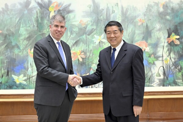 CORRECTS TO DELETE AN EXTRANEOUS PHRASE OF "A DELEGATION LED BY" - In this photo released by Xinhua News Agency, Chinese Vice Premier He Lifeng, right, shakes hands with Jay Shambaugh, the Under Secretary of U.S. Department of Treasury prior to their 3rd China-US Economic Working Group Meeting in Beijing, Tuesday, Feb. 6, 2024. (Yin Bogu/Xinhua via AP)