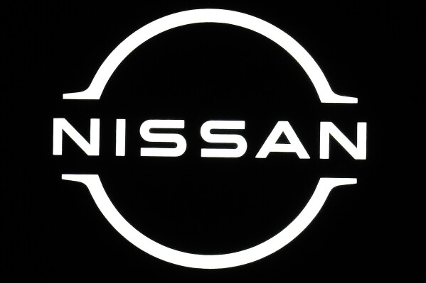 FILE - Logo of Nissan is seen at the Japan Mobility Show in Tokyo, on Oct. 26, 2023. Nissan's profit sank in October-December to about half of what it earned the year before, the automaker said Thursday, Feb. 8, 2024, though it stuck to its earlier earnings forecasts. (AP Photo/Eugene Hoshiko, File)