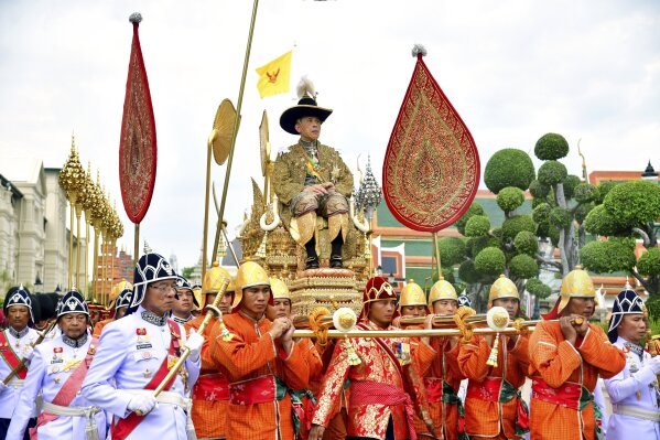 
              In this photo released by Thailand's Royal Public Relation Department, Thailand's King Maha Vajiralongkorn is transported on the royal palanquin by royal bearers during his visit to the Temple of the Emerald Buddhism, Saturday, May 4, 2019, in Bangkok, Thailand. Saturday began three days of elaborate centuries-old ceremonies for the formal coronation of Vajiralongkorn, who has been on the throne for more than two years following the death of his father, King Bhumibol Adulyadej, who died in October 2016 after seven decades on the throne. (Thailand's Royal Public Relation Department via AP)
            