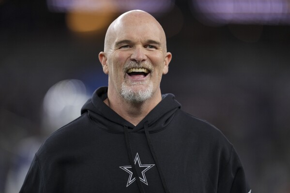 FILE - Dallas Cowboys defensive coordinator Dan Quinn looks on prior to an NFL football game against the Detroit Lions, Saturday, Dec. 30, 2023, in Arlington, Texas. The Washington Commanders have an agreement with Dallas Cowboys defensive coordinator Dan Quinn to hire him as coach, according to two people with knowledge of the decision. The people spoke to The Associated Press on condition of anonymity Thursday, Feb. 1, 2024, because the team had not yet announced the move.(AP Photo/Sam Hodde, File)