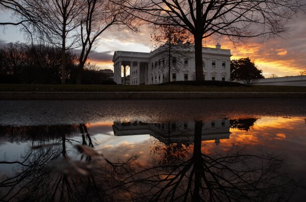 
              The sun rises behind the White House in Washington, Saturday, Dec. 22, 2018. Hundreds of thousands of federal workers faced a partial government shutdown early Saturday after Democrats refused to meet President Donald Trump's demands for $5 billion to start erecting a border wall with Mexico. Overall, more than 800,000 federal employees would see their jobs disrupted, including more than half who would be forced to continue working without pay. (AP Photo/Carolyn Kaster)
            