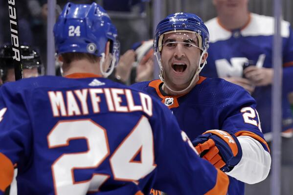 New York Islanders right wing Kyle Palmieri, right, reacts with defenseman Scott Mayfield (24) after scoring a goal in the second period of an NHL hockey game against the Anaheim Ducks, Sunday, March 13, 2022, in Elmont, N.Y. (AP Photo/Adam Hunger)